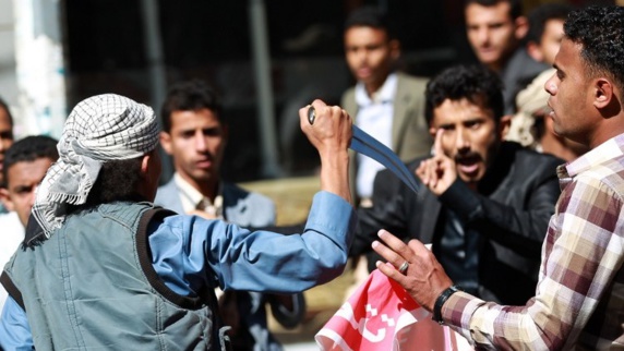 یکی از شورشیان گروه الحوثی در حال تهدید معترضان یمنی است یکی از شورشیان گروه الحوثی در حال تهدید معترضان یمنی است